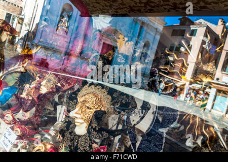 Reflections and masks in a shop window in Venice Italy Stock Photo