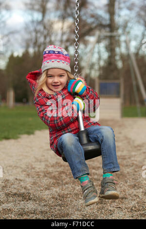 Child girl rids on Flying Fox play equipment in a children's playground. Seesaw, sliding, flying, rope slide Stock Photo