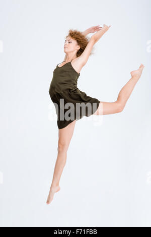 Full length portrait of a young woman dancing isolated on a white background Stock Photo