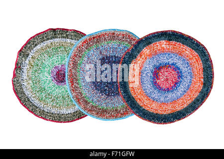 Three colorful handmade knitted rugs isolated on white background Stock Photo