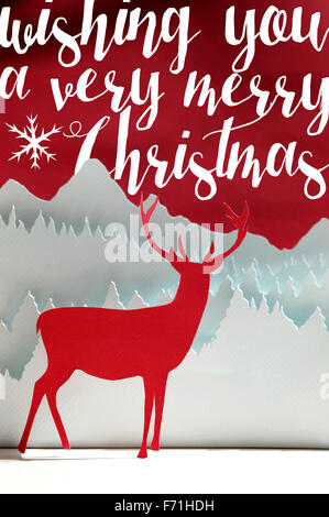 Merry christmas handmade paper cut art winter scene: red deer papercraft with snow forest landscape on text background. Stock Photo