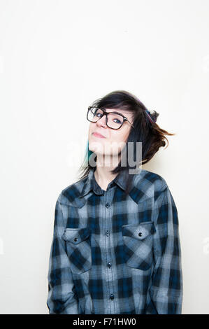 Pretty young alternative woman with big glasses smiling and looking at camera Stock Photo