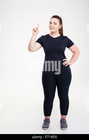 Smiling fat girl in sporty top and leggings holding dumbbells in hand  happily showing ok gesture while looking in camera over white background  Stock Photo - Alamy
