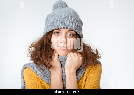 Portrait of a young woman with scarf and hat looking at camera isolated on a white background Stock Photo