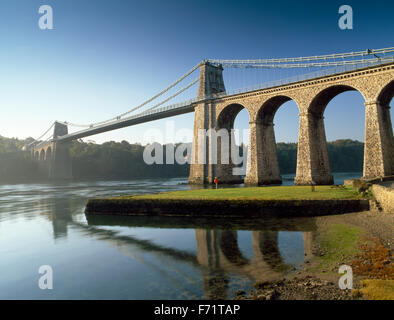 The Menai Suspension Bridge from sea level on the  Anglesey shore to the mainland. Menai Bridge, Anglesey, North Wales, UK Stock Photo