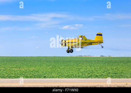 Crop duster aircraft spraying farm field, near Regina, Saskatchewan, Canada. Stock Photo