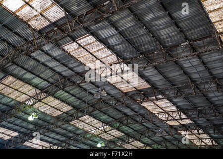 Background of a rusty corrugated iron roof with skylights. Stock Photo