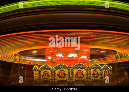 The light trails of a fairground carousel ride captured with a long exposure Stock Photo