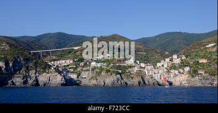 A panoramic view from the sea of Riomaggiore Village in the Cinque Terre Natural Park, Italy. Stock Photo