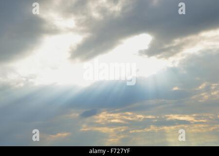 An amazing cloudy sky with light rays and beams of light. Stock Photo