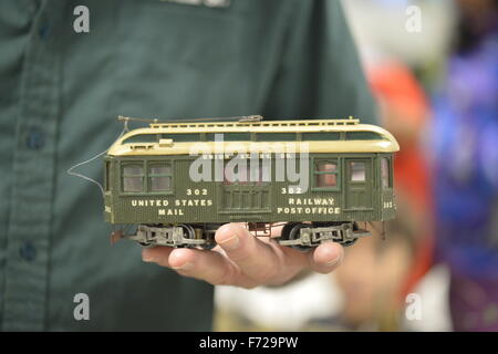 Bethpage, New York, USA. 22nd November 2015. FRANK KOBYLARZ, a co-founder of the Long Island Traction Society, holds a green Scratch Built 202 United States Mail Railway Post Office Trolley car. Kobylarz explained his O-Gauge trolley was not built from a kit but from basic materials such as wood, and that the original trolley it is modeled on operated from 1922-1937 in NY, NJ, New Haven, Bronx, Brooklyn. The trolley trains layout is one of several operating layouts at the 6th Annual Nassau County Model Train Show, held at the Bethpage Senior Community Center.