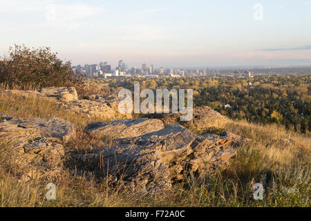 Sandstone outcrop of the Porcupine Hills Formation in Nose Hill Park overlooking downtown Calgary skyline Stock Photo