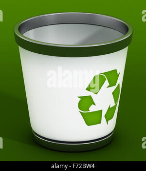 Recycle bin standing on green background Stock Photo