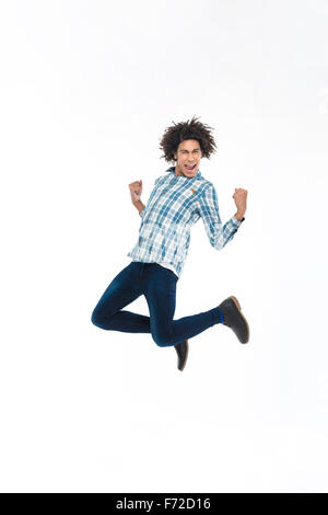 Full length portrait of a cheerful afro american man jumping isolated on a white background Stock Photo