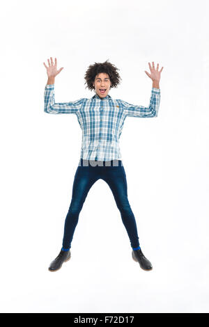 Full length portrait of a funny afro american man jumping isolated on a white background Stock Photo