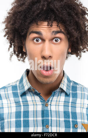 Portrait of a shocked afro american man with curly hair looking at camera isolated on a white background Stock Photo