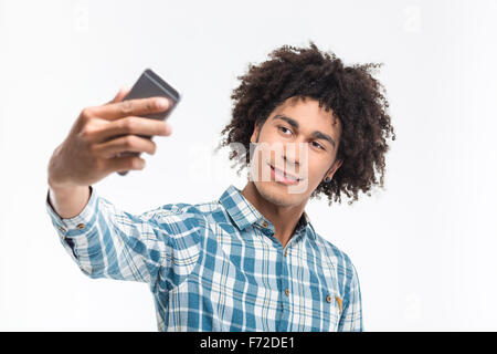 Portrait of a happy afro american man making selfie photo on smartphone isolated on a white background Stock Photo