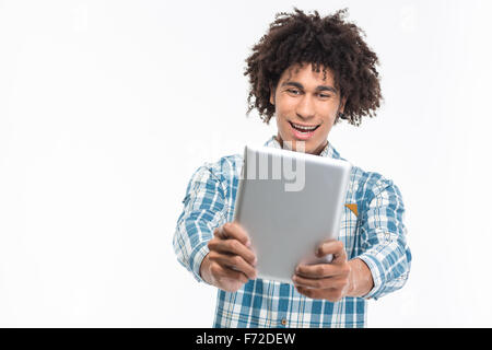 Portrait of a cheerful afro american man using tablet computer isolated on a white background Stock Photo