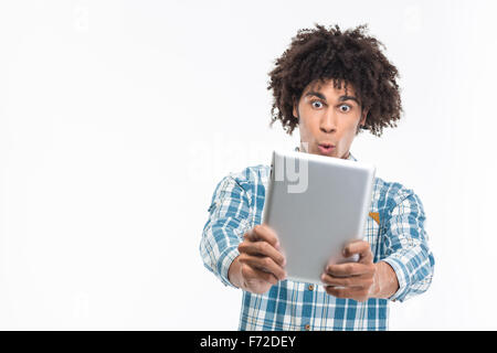 Portrait of a funny afro american man using tablet computer isolated on a white background Stock Photo