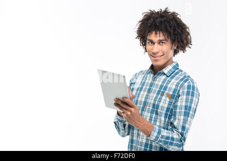 Portrait of a smiling afro american man using tablet computer isolated on a white background and looking at camera Stock Photo