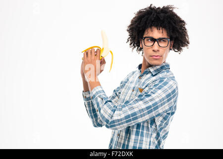 Portrait of a funny afro american man holding banana isolated on a white background Stock Photo
