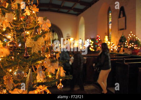 Tress are decorated for a Christmas Tree Festival inside St Edmund's Church in Derbyshire's Peak District, England UK Stock Photo