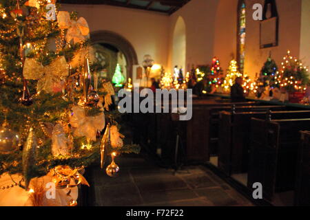 Tress are decorated for a Christmas Tree Festival inside St Edmund's Church in Derbyshire's Peak District, England UK Stock Photo