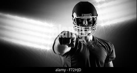 Composite image of american football player pointing at camera Stock Photo