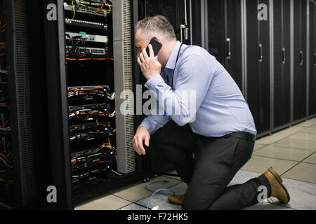 Technician working on broken server Stock Photo - Alamy