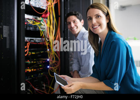 Team of technicians working together on servers Stock Photo