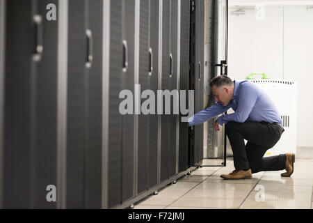 Technician walking in server hallway Stock Photo
