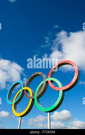 LONDON, UK - OCTOBER 14, 2015: A large display of the Olympic rings stands in bright blue sky in Queen Elizabeth Olympic Park. Stock Photo