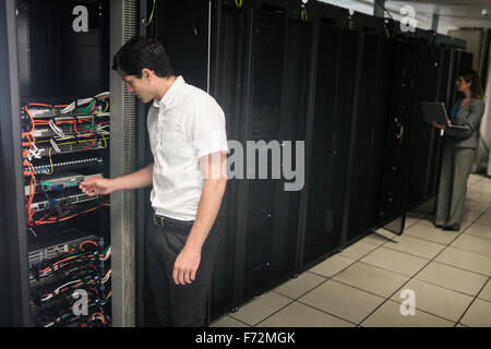 Team of technicians working on servers Stock Photo