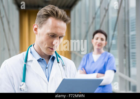 Doctor using his tablet pc Stock Photo
