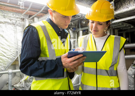 Engineers working in temperature control room Stock Photo