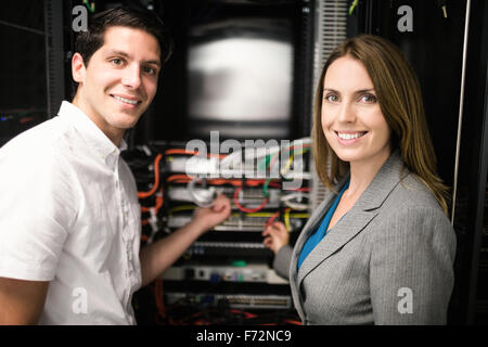 Team of technicians working together on servers Stock Photo