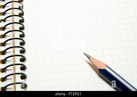 Opened notebook with a blank sheet and pencil on over white Stock Photo