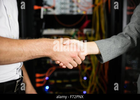 Team of technicians working together on servers Stock Photo