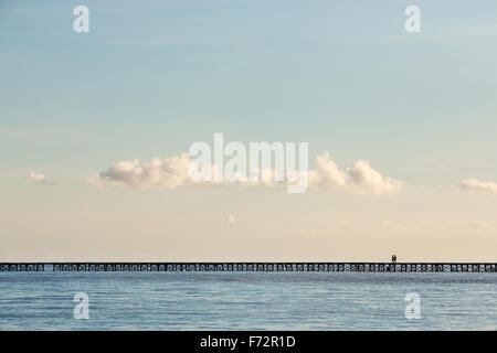 People from the Bajo village on the Togean Islands crossing the bridge to the mainland, Indonesia.