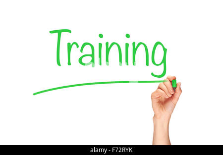 A woman's hand writing the word, Training, on a clear screen. Stock Photo
