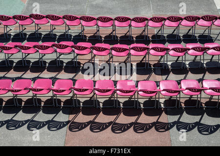 Rows of empty chairs in the sunshine at Eastbourne Bandstand, Eastbourne, East Sussex, England, UK Stock Photo