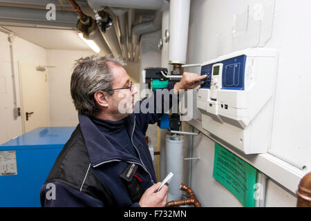Caretaker checks the heating system in the boiler room Stock Photo