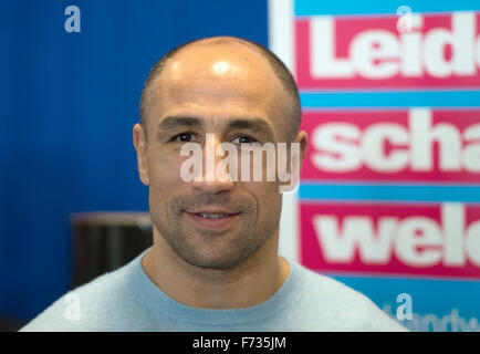 Berlin, Germany. 24th Nov, 2015. Boxing world champion Arthur Abraham poses in front of a poster that reads 'Leidenschaft welcome' (lit. Passion welcome) at the Max Schmeling Gymnasium in Berlin, Germany, 24 November 2015. Photo: SOEREN STACHE/dpa/Alamy Live News Stock Photo