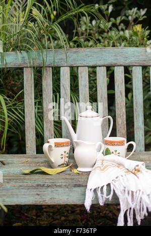 https://l450v.alamy.com/450v/f736tp/coffee-pot-and-mugs-on-a-wooden-garden-bench-f736tp.jpg