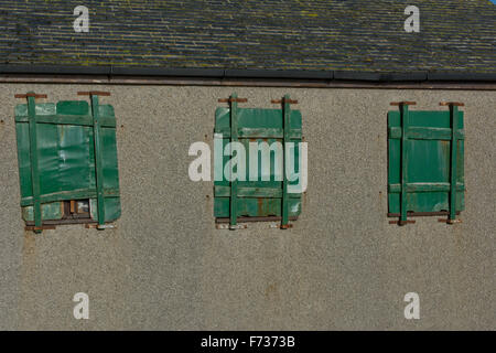 Boarded up windows on outside of public convenience. Stock Photo