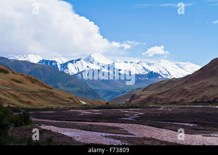 Spectacular panorama of the Pamirs in Tajikistan viewed from Kyrgyzstan on the way towards Sary-Tash. Stock Photo