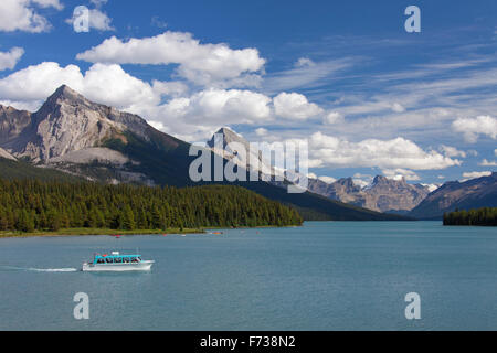 Canoes and tourist boat on Maligne Lake in the Jasper National Park, Alberta, Canadian Rockies, Canada Stock Photo