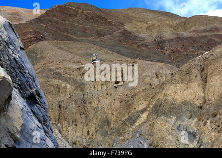 Prayer flags-small shrine halfway up the mountain on Bonbori Hill-right bank of Trum or Chong Chu river. Sakya monastery-Tibet. Stock Photo