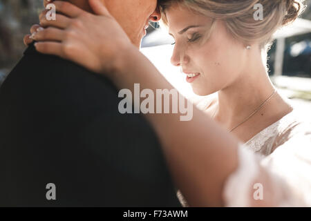 bride and groom posing on the streets Stock Photo