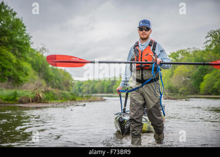 Angler Throws Up Peace Sign While Dragging on the Brazos River in Texas Stock Photo